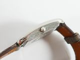 an image of a close up of a watch on a white surface