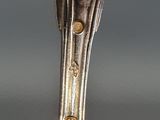 a spoon with a flower on it sitting on a table