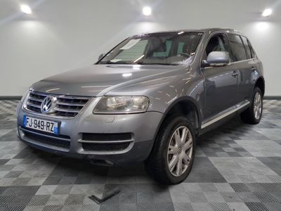 a picture of a silver volkswagen suv parked in a garage