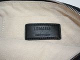 the inside of a black and white purse with a leather label