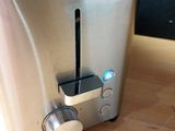 a close up of a toaster on a wooden table