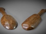 two wooden spoons sitting on top of a table next to each other
