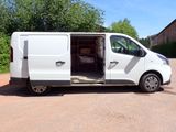 a white van parked in a parking lot with its doors open