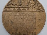 a plaque on the wall of a building with a picture on it