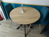 a small table with two chairs and a vase on it