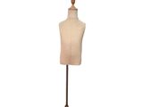 a mannequin on a wooden stand with a white background