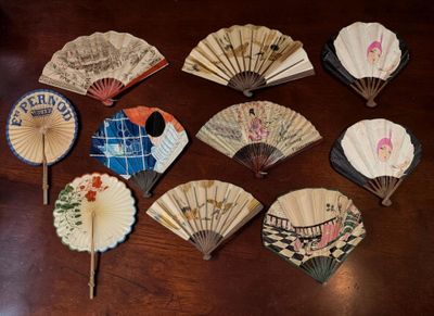 many different types of paper fans on a table