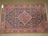 an antique persian rug with a diamond design on it