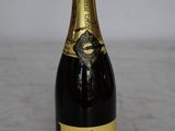 an image of a bottle of champagne sitting on a table