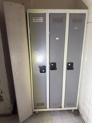 two lockers in the corner of a bathroom