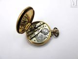 an image of a pocket watch with a gold case on a white surface