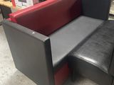a black and red couch and a red ottoman in a store