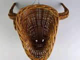 a wicker basket hanging from the ceiling on the wall