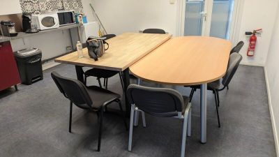 a table and chairs in a room with a microwave and a microwave oven