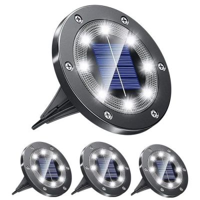 a close up of four solar powered lights on a white background
