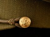 a hat that has a gold coin on it