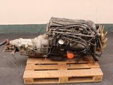 a small engine sitting on a pallet on the ground
