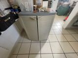 a small refrigerator in the middle of a kitchen floor