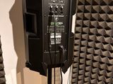 a speaker that is sitting on a stand in a room