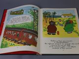 an open book with a picture of a train on it
