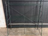 a metal rack with a shelf on it in front of a door