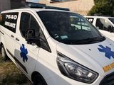 a white van that is parked next to a building
