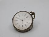 a small silver pocket watch with roman numerals on it