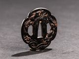 a close up of a tsuba with a dragon on it