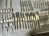 a lot of spoons and forks on the table