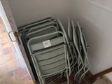 a lot of chairs that are stacked up against the wall