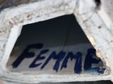 a close up of a piece of metal with the word femme written on it