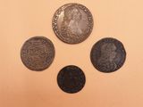 three different types of coins are shown on a white surface