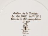 a white plate with a picture of a lighthouse on it