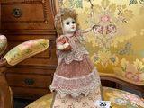 a doll that is sitting on a chair in a room