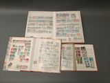 three open books with stamps on them sitting on a table