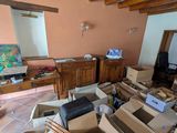 a room filled with boxes and a computer on the desk