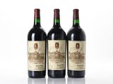 three bottles of wine sitting on top of a white surface