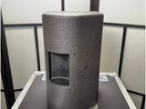 an image of a speaker on top of a case in a room