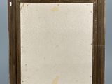 an old picture frame sitting on top of a metal stand