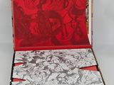 an open box with comics on it sitting on a white surface