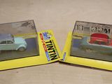 two toy cars that are sitting on a table