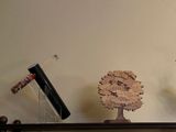 two vases on a shelf with a tree on top of it
