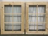 two wooden windows that are next to each other