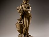 statue of a woman holding a vase and a baby