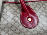 a brown and red purse with a red handle