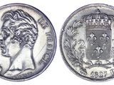 a silver coin with a crown on top of it