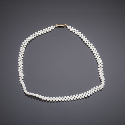 a white pearl necklace with a gold clasp