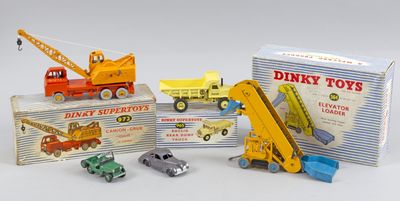 Plusieurs petites voitures et camions sont posés sur une table