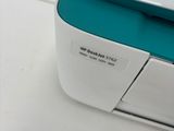 a blue and white printer sitting on a white table