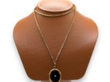 a close up of a necklace on a mannequin on a white background
